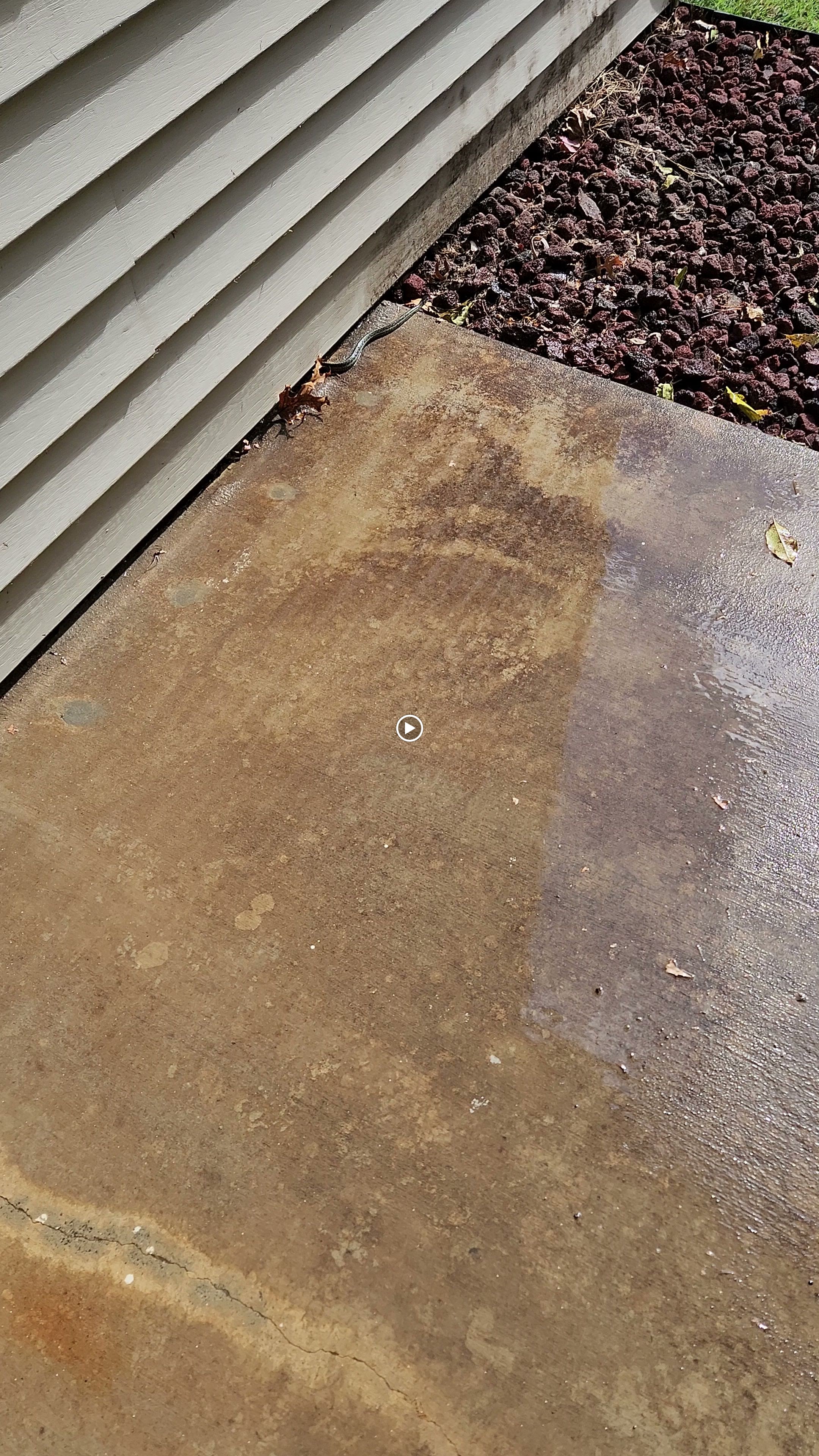 Video preview showing a concrete area alongside house siding