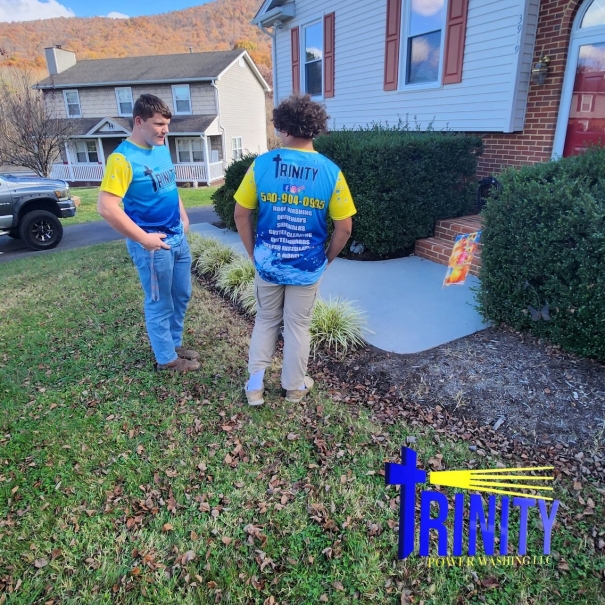 The Trinity team in blue and yellow work shirts at a customer’s home